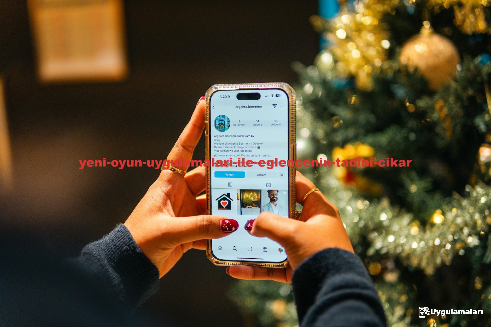 Person using a smartphone near a Christmas tree with a festive atmosphere.