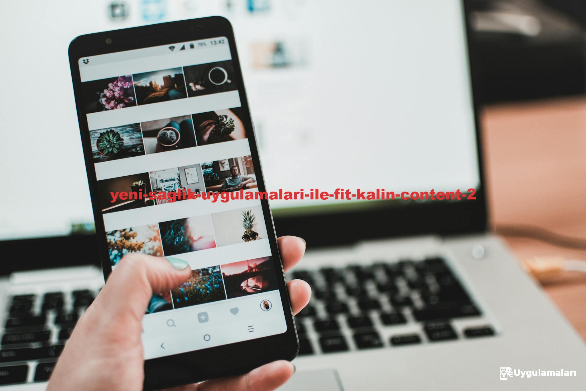 A person uses a smartphone to browse social media in front of a laptop, emphasizing modern technology and lifestyle.