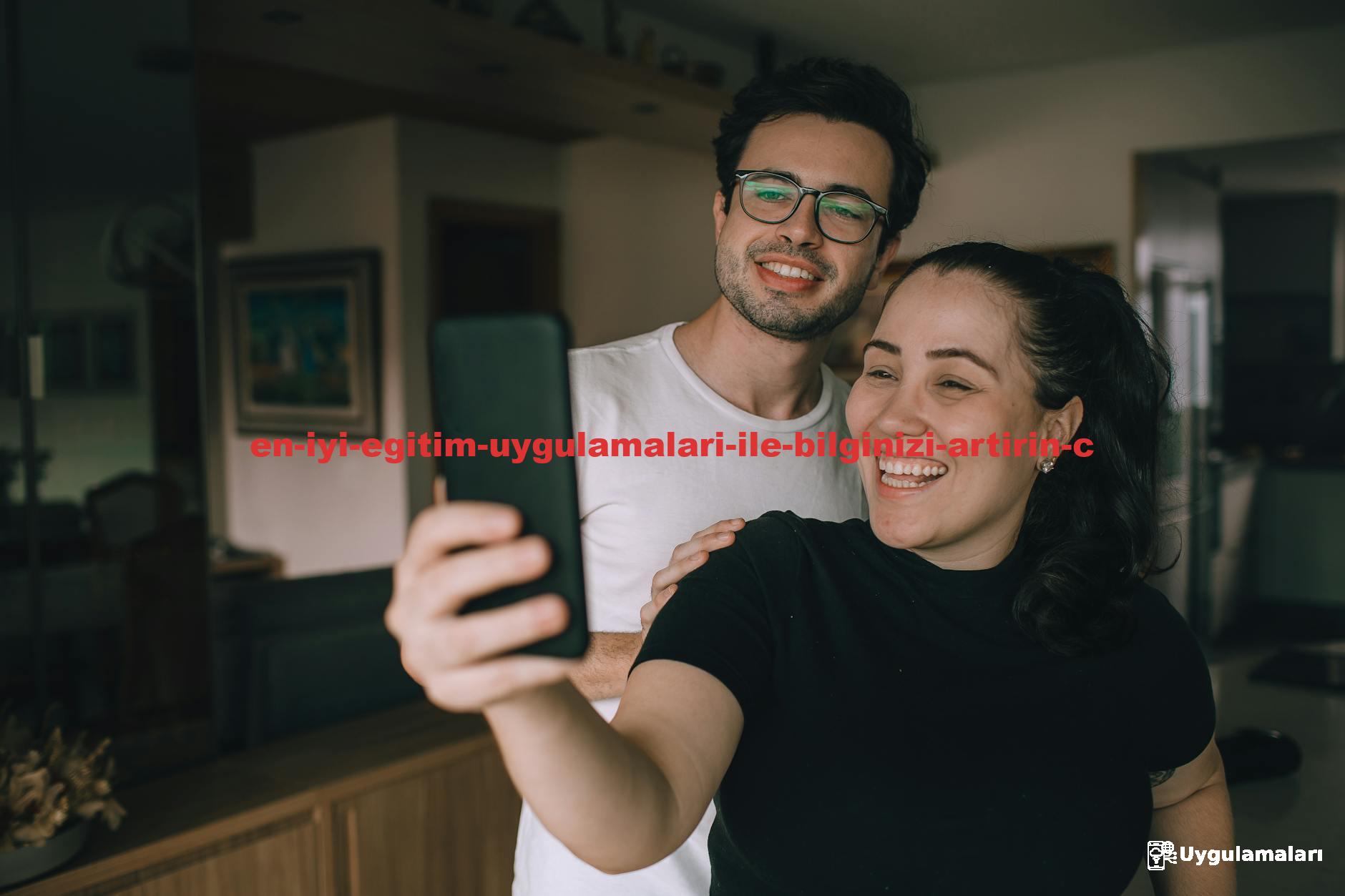 Smiling couple taking a selfie inside their home, enjoying a joyful moment together.