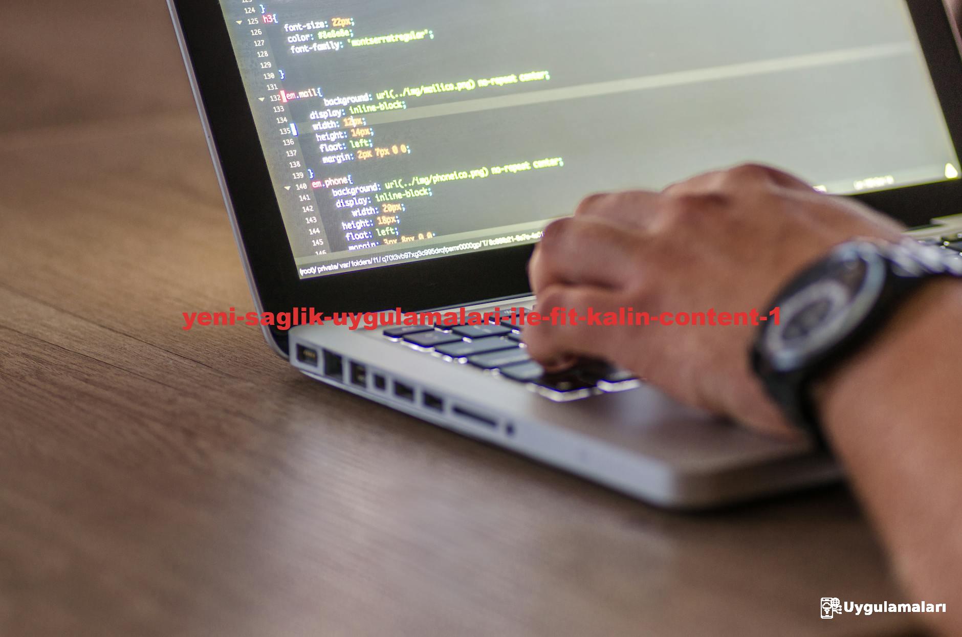A close-up shot of a person coding on a laptop, focusing on the hands and screen.