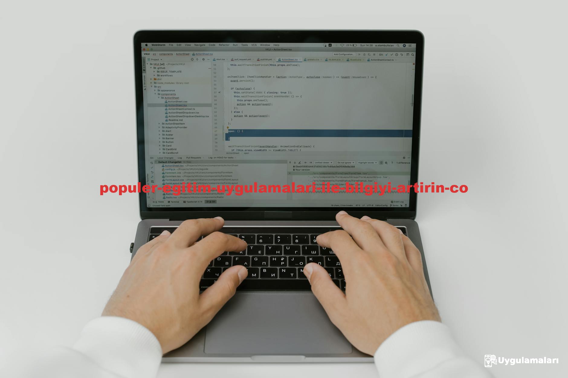 Close-up of hands coding on a laptop, showcasing software development in action.