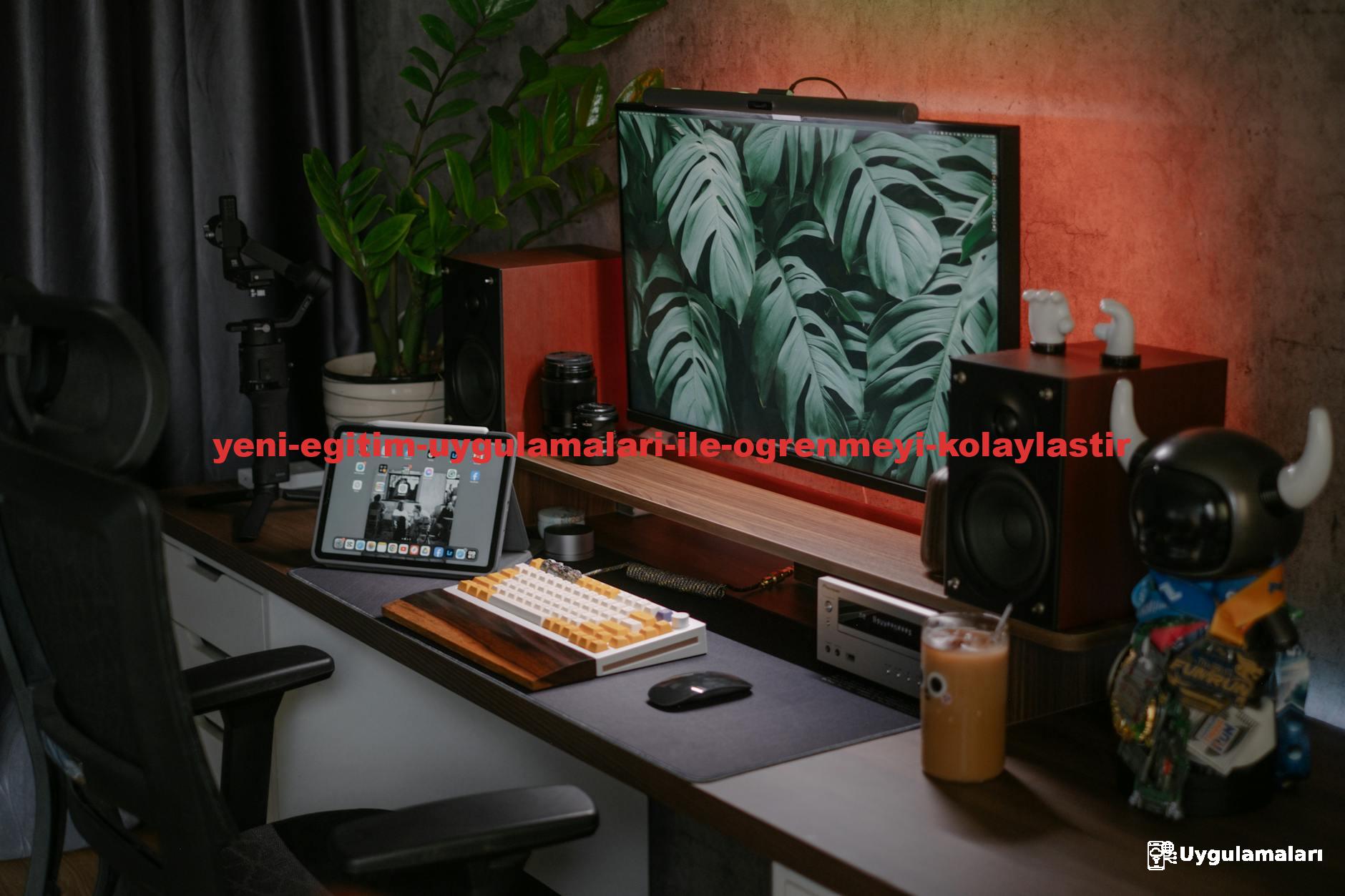 A stylish home office setup featuring a monitor, tablet, speakers, and decorative items. Ideal for tech enthusiasts.