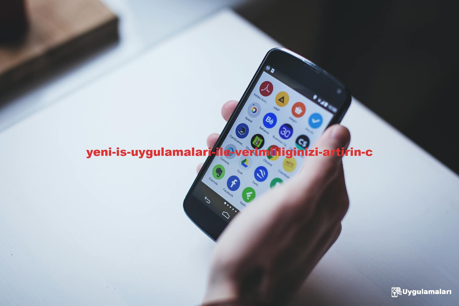 Close-up of a person holding a smartphone with various app icons visible on the screen.